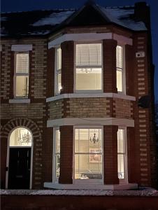 a large brick building with white windows on the front at My Big House Up North Grappenhall Warrington in Warrington