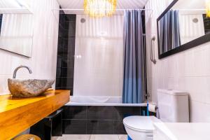a bathroom with a sink and a bath tub at epicenter CITY in Ponta Delgada +34 photos