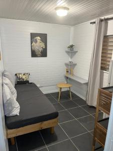a small bedroom with a bed and a table at Bungalows Caraibes et Goyave proches de la route mais calme la nuit in Trois-Rivières +14 photos
