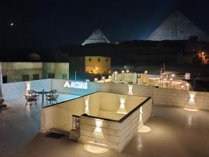 a fire pit on the roof of a building at night at Antique Pyramids Inn in Giza