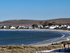 a view of a beach with houses and the water at SeeSkattie in St. Helena Bay