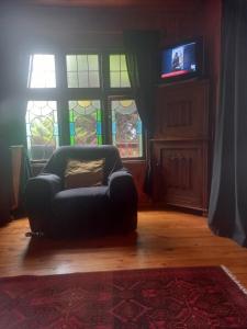 a couch in a living room with stained glass windows at Emerald Hill Cabin in Mount Pleasant