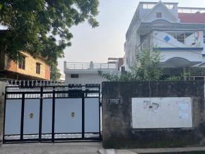 a black gate in front of a building at Parmanand Niwas Homestay in Prayagraj