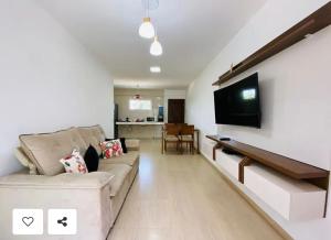 カウカイアにあるBeach Place Cumbucoのソファと薄型テレビのあるリビングルーム