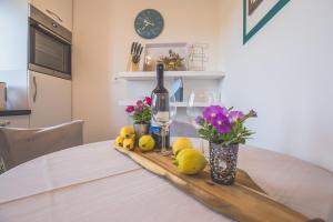 a table with a bottle of wine and lemons on it at Violet Seaview Apartment in Vis +16 photos
