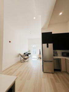 a kitchen with a refrigerator in the middle of a room at On Trend - 427 Haven in Woodstock