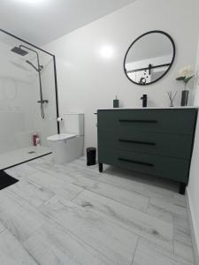a bathroom with a green dresser and a mirror at Casa Encarnita in Arcos de la Frontera +30 photos