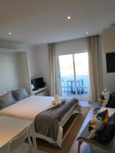 a bedroom with a large bed and a balcony at Bay View Albufeira in Albufeira