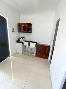 a kitchen with a table and two chairs in a room at Lazer Atalaia in Salinópolis