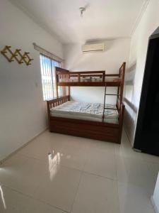 a bedroom with two bunk beds and a flat screen tv at Lazer Atalaia in Salinópolis