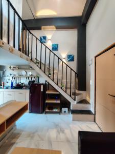 a kitchen with a staircase in a house at Zen Haven - Luxury Ganga Access & Mountain View in Rishīkesh