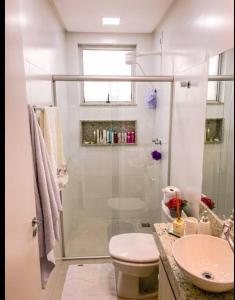 a bathroom with a shower and a toilet and a sink at Casa térrea , bem localizada in Belém