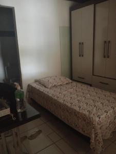 a small bedroom with a bed and a cabinet at Casa térrea , bem localizada in Belém