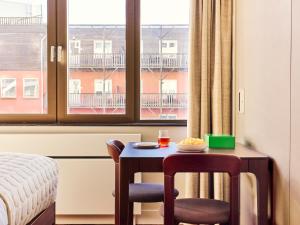 a room with a table and two chairs and a window at Numa The Hague Scheveningen in Scheveningen +95 photos