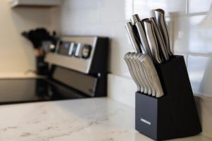 a black knife block filled with wooden utensils at Raleigh With Daylor in Raleigh