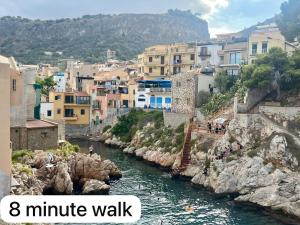 a view of a river in a city with buildings at Casa Yasmine in Santa Flavia