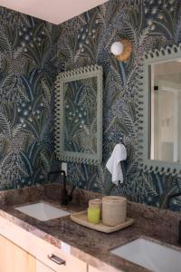 a bathroom with two sinks and a mirror at Luxury Lakefront 5 Br Home Hot Tub Arcade in Truckee