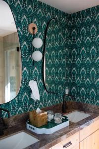 a bathroom with a sink and a mirror at Luxury Lakefront 5 Br Home Hot Tub Arcade in Truckee +122 photos