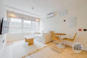 a living room with a couch and a table at Malasaña a tus pies para 4, descubre San Bernardo 20 E3 in Madrid