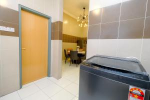 a room with a door and a table with a dining room at Arista Guest House in Pangkor