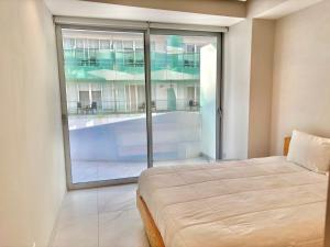a bedroom with a bed and a large window at Park Life Nautico in Nuevo Vallarta +35 photos