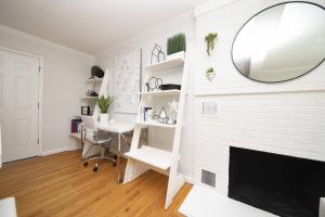 a white room with a fireplace and a mirror at Admiral's Retreat - iTrip Annapolis in Annapolis