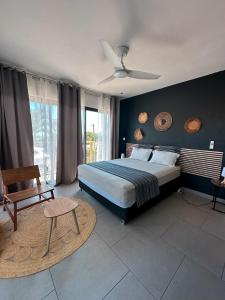 a bedroom with a bed and a ceiling fan at Forecastle House in Saint-Louis +6 photos