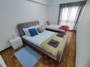 a small bedroom with a bed and a window at Lisbon spacious T2 in Damaia, Lisbon in Amadora