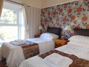 a hotel room with two beds and a window at The Hub at Abercrave in Abercraf