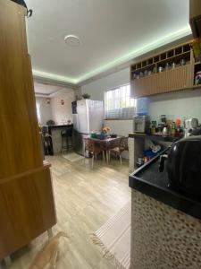 a kitchen with a counter and a table in a room at Casa Cop 30 in Belém +2 photos