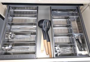 a drawer with cutlery and utensils in it at Urban Nest Kalymnos in Kalymnos