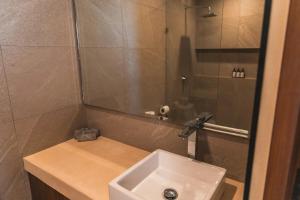 a small bathroom with a sink and a shower at Breathtaking Ocean Vista Penthouse with Private Pool in Holbox Island +59 photos
