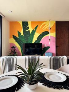 a living room with a table with two plates on it at Breathtaking Ocean Vista Penthouse with Private Pool in Holbox Island