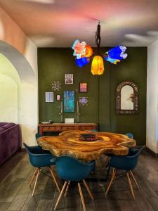 a dining room with a wooden table and blue chairs at Casita El Nido- Spacious 2 Bedroom Main Floor Apartment in Bucerías