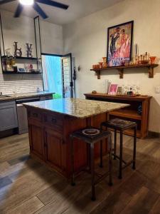 a kitchen with a counter and a island with stools at Casita El Nido- Spacious 2 Bedroom Main Floor Apartment in Bucerías +6 photos