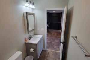 a white bathroom with a sink and a mirror at New 2 BR Unit in Prime Location (103) in Maryville +27 photos