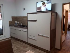 a kitchen with a tv on top of a refrigerator at Ferienwohnung Funke F2 für Monteure in Apolda