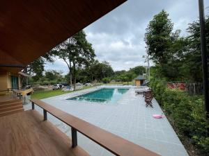 a view of a swimming pool from a house at Jindarin Villas จินดาริน คาเฟ่ in Ban Nong Sarai (1)