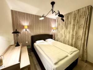 a bedroom with a bed and a table and lights at Luxury 2 Bedrooms Ocean View Iguazu in Playa del Ingles +27 photos