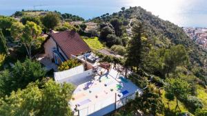 an aerial view of a house on a hill at Villa Charlene - Pool, Peace, Jacuzzi and Ligurian Views in Ventimiglia