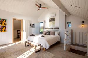 a bedroom with a bed and a ceiling fan at Villa Charlene - Pool, Peace, Jacuzzi and Ligurian Views in Ventimiglia +106 photos