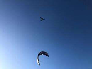 a kite and an airplane flying in the sky at Lar Torus Eco Lodge - Kite is Surf in Tatajuba