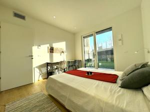 a bedroom with a large bed with a red blanket on it at Borgo Garda in Peschiera del Garda +32 photos