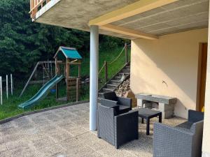 a playground with a slide and a slideintendangering at Grand gîte du Bruleux 11 personnes in La Bresse