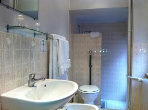 a bathroom with a sink and a toilet and a shower at La Bonne Franquette in Villé +41 photos
