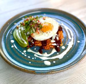 a plate of food with an egg on top at Casa Palencia Hotel and Breakfast in Mazatlán
