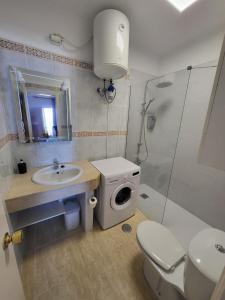 a bathroom with a toilet sink and a shower at Adeje Paraíso in Adeje