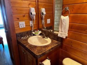 a bathroom with a sink and a hair dryer at Westport Marina Cottages in Westport +69 photos