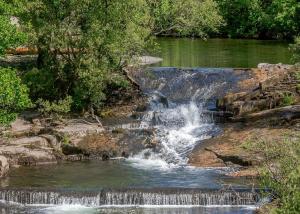 a waterfall on the side of a river at Ogwen Bank Caravan And Lodge Park in Bethesda +136 photos