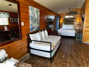 a room with two beds and a table in a room at Westport Marina Cottages in Westport